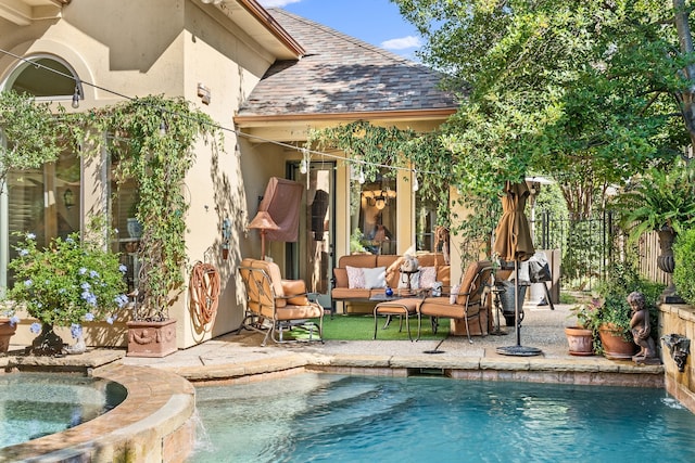 view of swimming pool with an in ground hot tub, a patio area, outdoor lounge area, and pool water feature