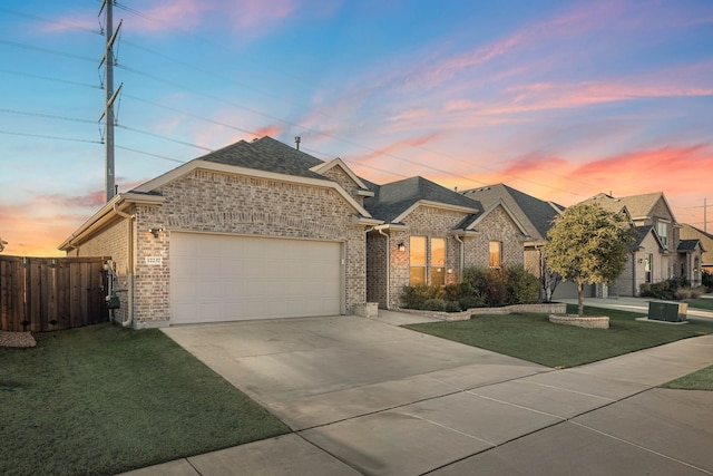 view of front of home with a yard and a garage