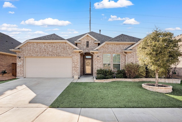 view of front of house featuring a garage and a front yard