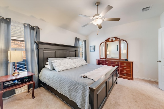 bedroom with ceiling fan, lofted ceiling, light carpet, and multiple windows