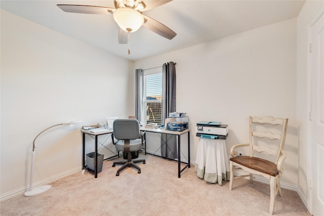 carpeted office space featuring ceiling fan