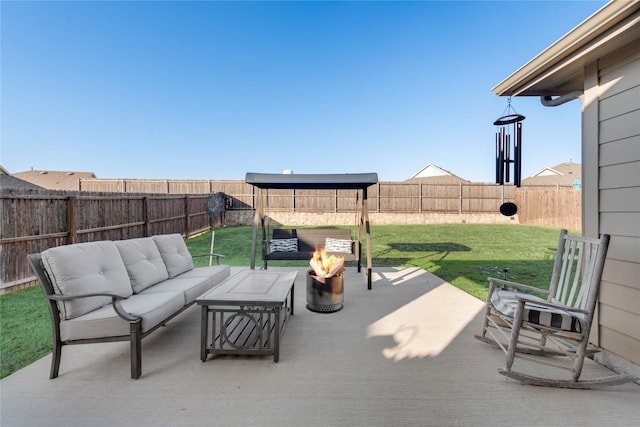 view of patio featuring an outdoor living space with a fire pit