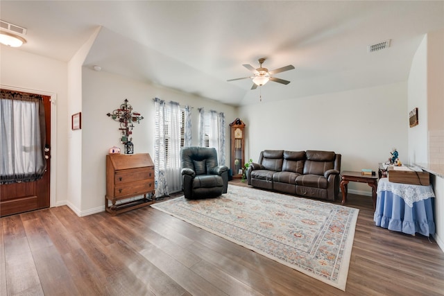 living room featuring ceiling fan and dark hardwood / wood-style flooring