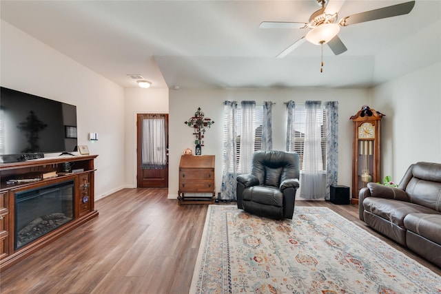 living room with hardwood / wood-style floors and ceiling fan