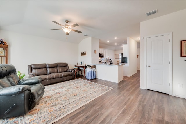 living room featuring ceiling fan and wood-type flooring