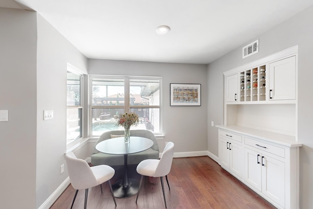 dining area featuring dark wood-type flooring