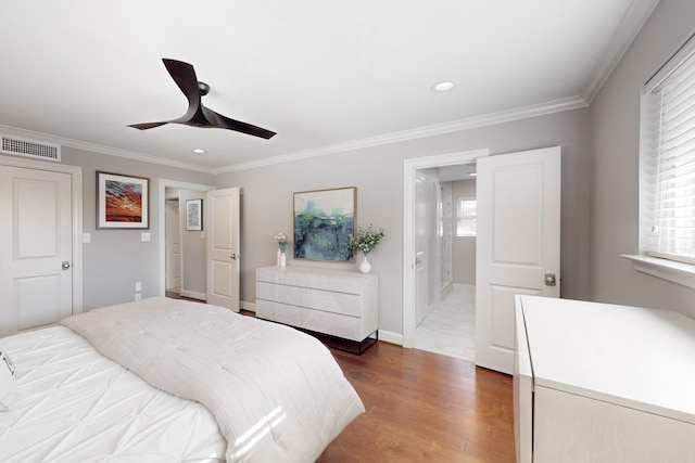 bedroom featuring multiple windows, ornamental molding, dark hardwood / wood-style floors, and ceiling fan