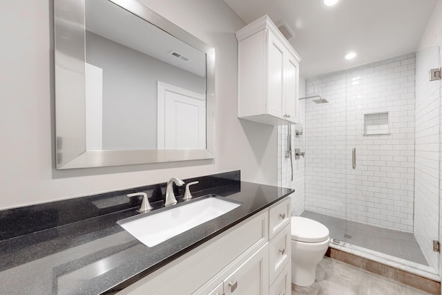 bathroom featuring walk in shower, vanity, and toilet