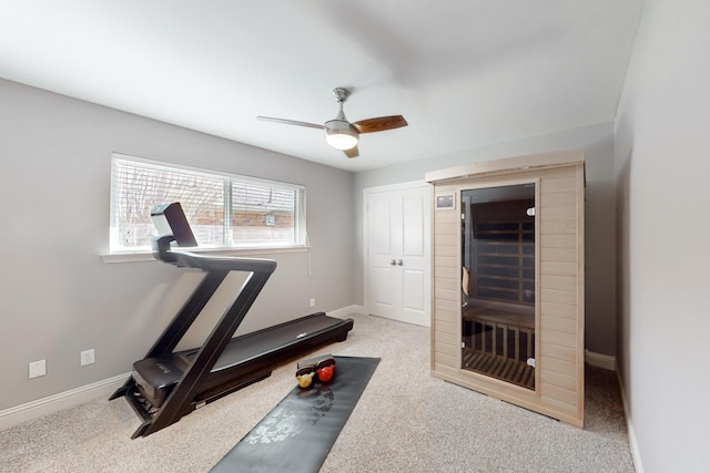 exercise area featuring light colored carpet and ceiling fan