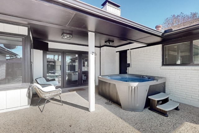 view of patio / terrace with a hot tub