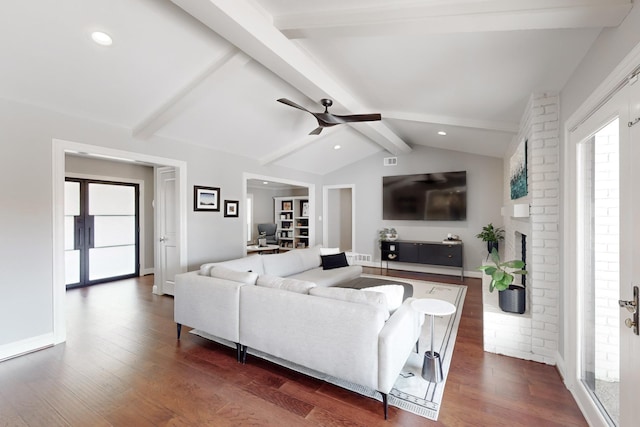 living room featuring vaulted ceiling with beams, a fireplace, dark hardwood / wood-style floors, and ceiling fan