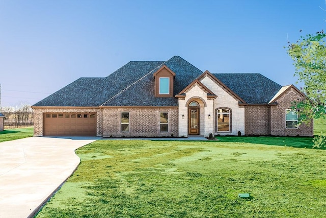 french country home with a garage and a front yard