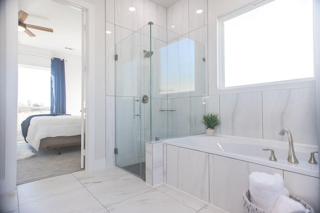 bathroom featuring ceiling fan and independent shower and bath