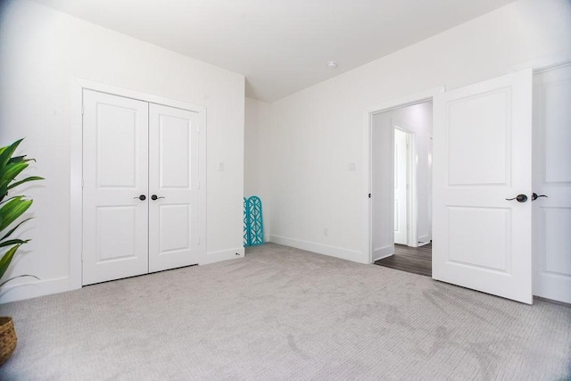 unfurnished bedroom featuring carpet floors and a closet