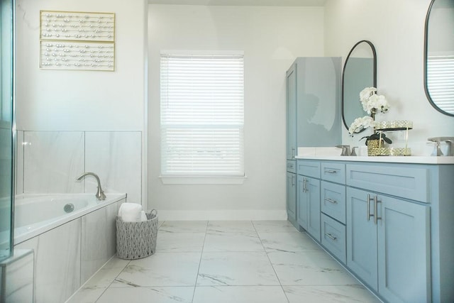 bathroom featuring a bath and vanity