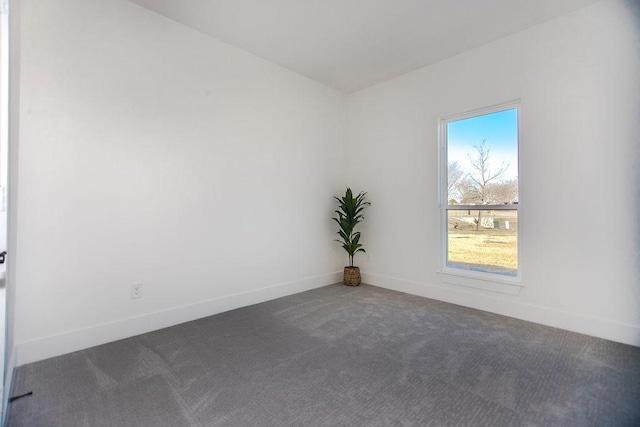 unfurnished room with dark colored carpet