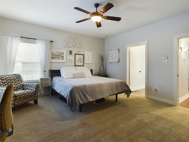 bedroom featuring ceiling fan and carpet