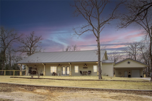 single story home with a garage and ceiling fan