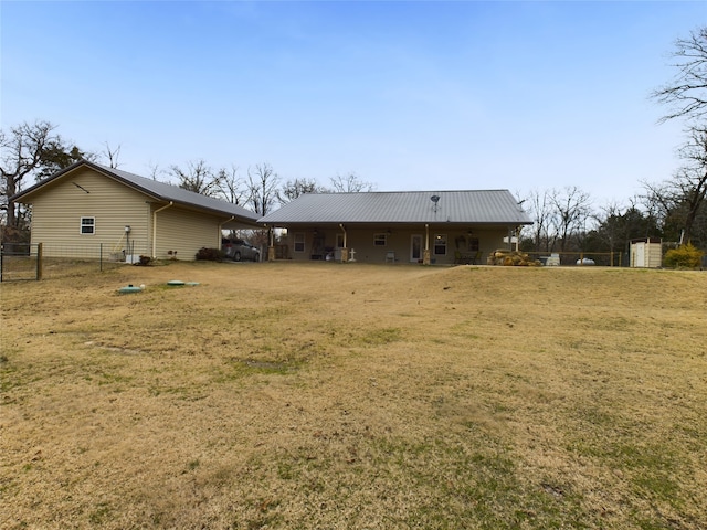 rear view of property featuring a lawn