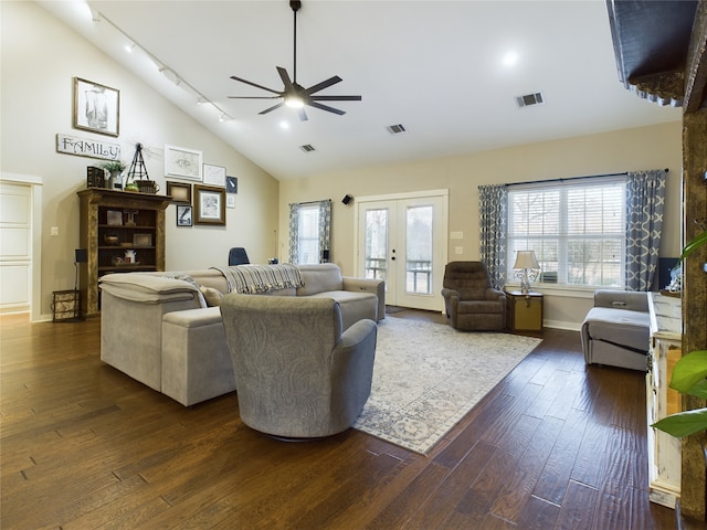 living room with ceiling fan, dark hardwood / wood-style floors, lofted ceiling, and french doors