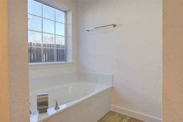 bathroom featuring hardwood / wood-style floors and a bathtub