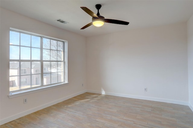 spare room featuring light wood-type flooring and ceiling fan