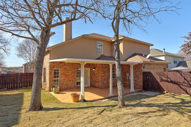 back of house with a patio area and a yard