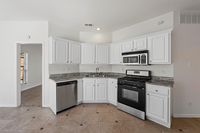 kitchen featuring sink, stainless steel appliances, white cabinets, and light tile patterned floors