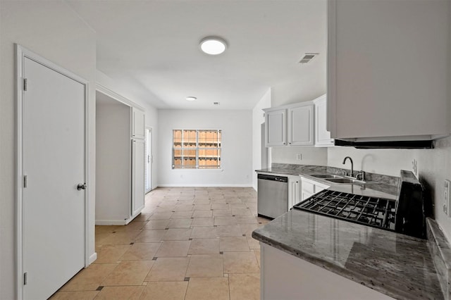 kitchen with white cabinetry, stainless steel dishwasher, sink, dark stone countertops, and light tile patterned flooring