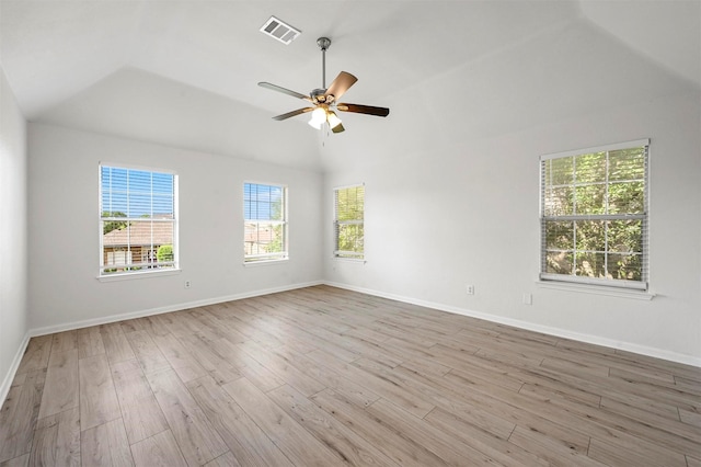 empty room with lofted ceiling, light wood-type flooring, and ceiling fan