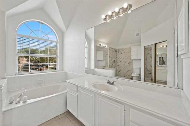 bathroom featuring toilet, tile patterned flooring, a washtub, vanity, and vaulted ceiling