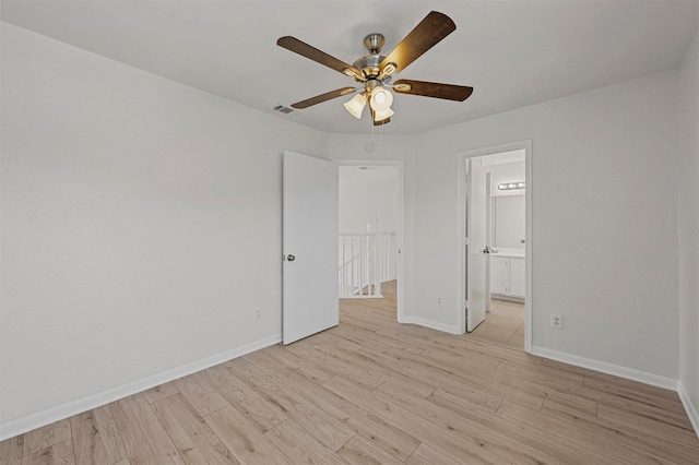 unfurnished bedroom featuring light hardwood / wood-style floors, connected bathroom, and ceiling fan