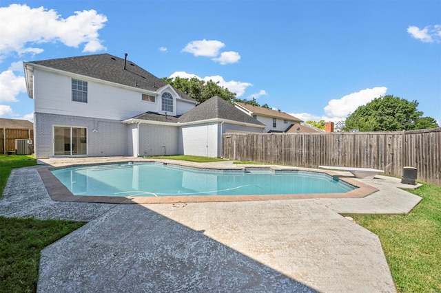 view of pool with a diving board, central air condition unit, and a patio area