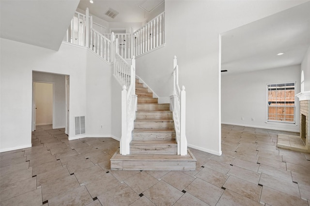 stairs featuring a high ceiling and tile patterned floors