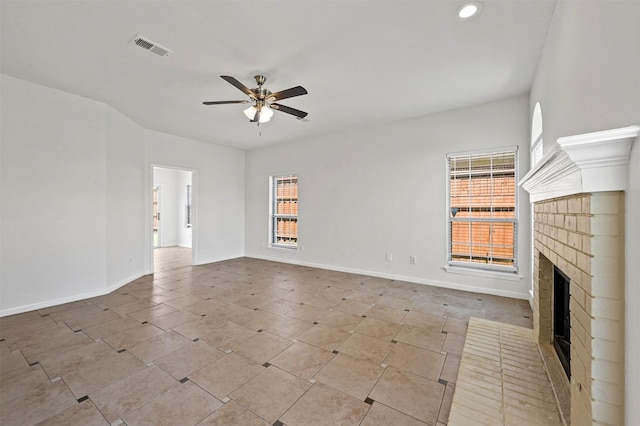 unfurnished living room with ceiling fan and a fireplace