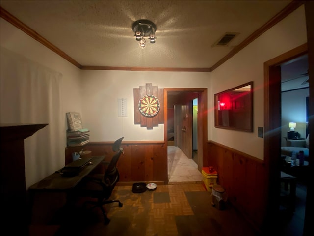 hall featuring crown molding, parquet flooring, a textured ceiling, and wooden walls