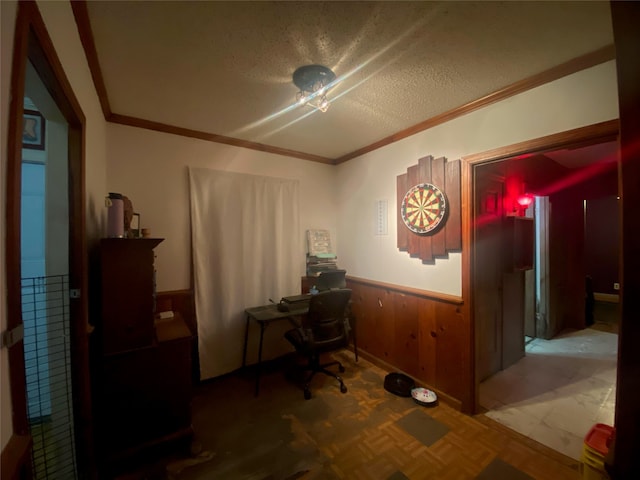 office with parquet floors, wooden walls, a textured ceiling, and crown molding