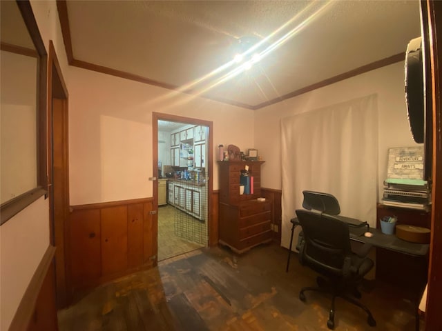 home office with dark hardwood / wood-style floors and wood walls