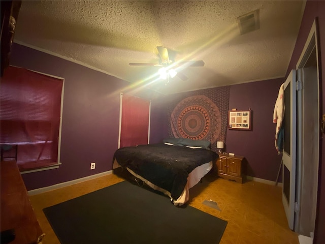 bedroom with a textured ceiling and ceiling fan