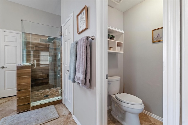 full bath featuring toilet, a shower stall, baseboards, and tile patterned flooring