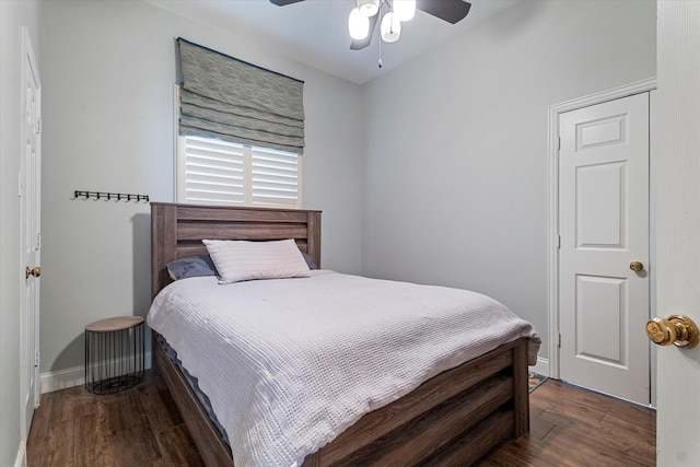 bedroom with ceiling fan, dark wood finished floors, and baseboards