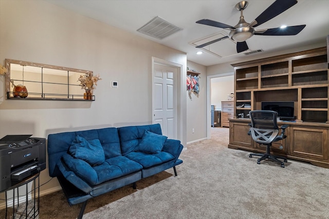 office area with light carpet, baseboards, visible vents, and ceiling fan