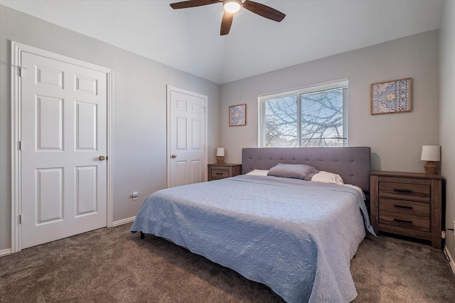 bedroom featuring a ceiling fan, lofted ceiling, baseboards, and dark colored carpet