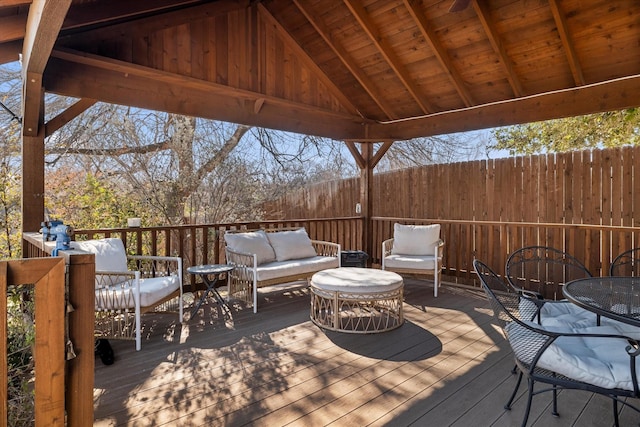 deck with fence and an outdoor living space