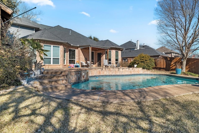 view of swimming pool with a patio, a lawn, fence, and a fenced in pool