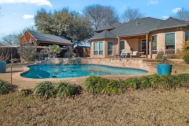 outdoor pool with a patio and fence