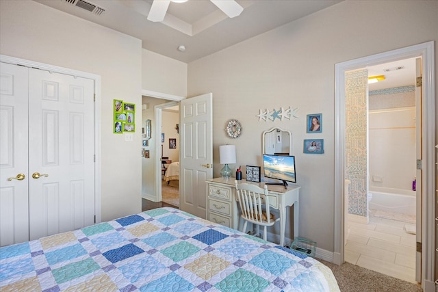 bedroom featuring ceiling fan, ensuite bathroom, carpet floors, and a closet