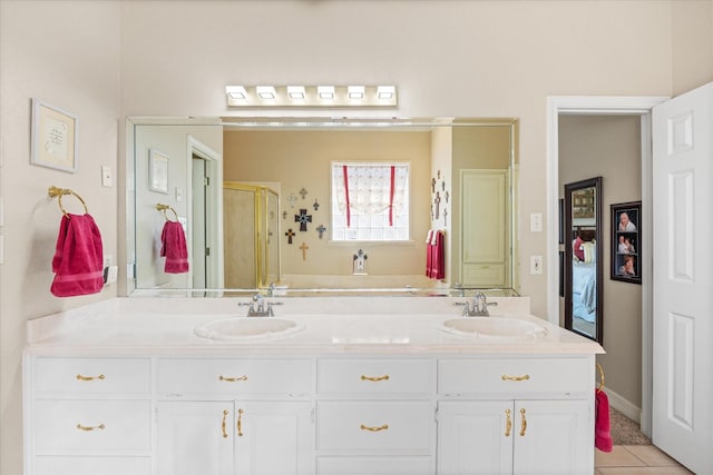 bathroom featuring vanity, a shower with shower door, and tile patterned floors