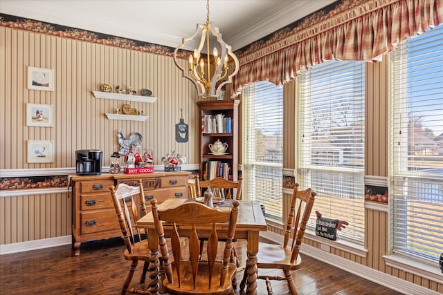 dining room with dark hardwood / wood-style floors and an inviting chandelier