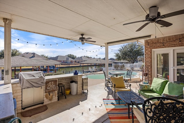 view of patio / terrace with a fenced in pool, an outdoor hangout area, grilling area, and a bar